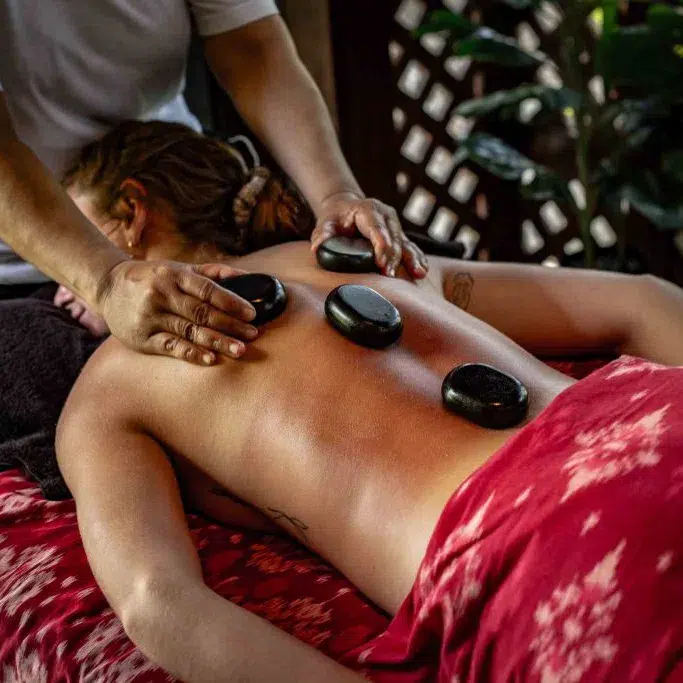 Woman enjoying a hot stone massage.